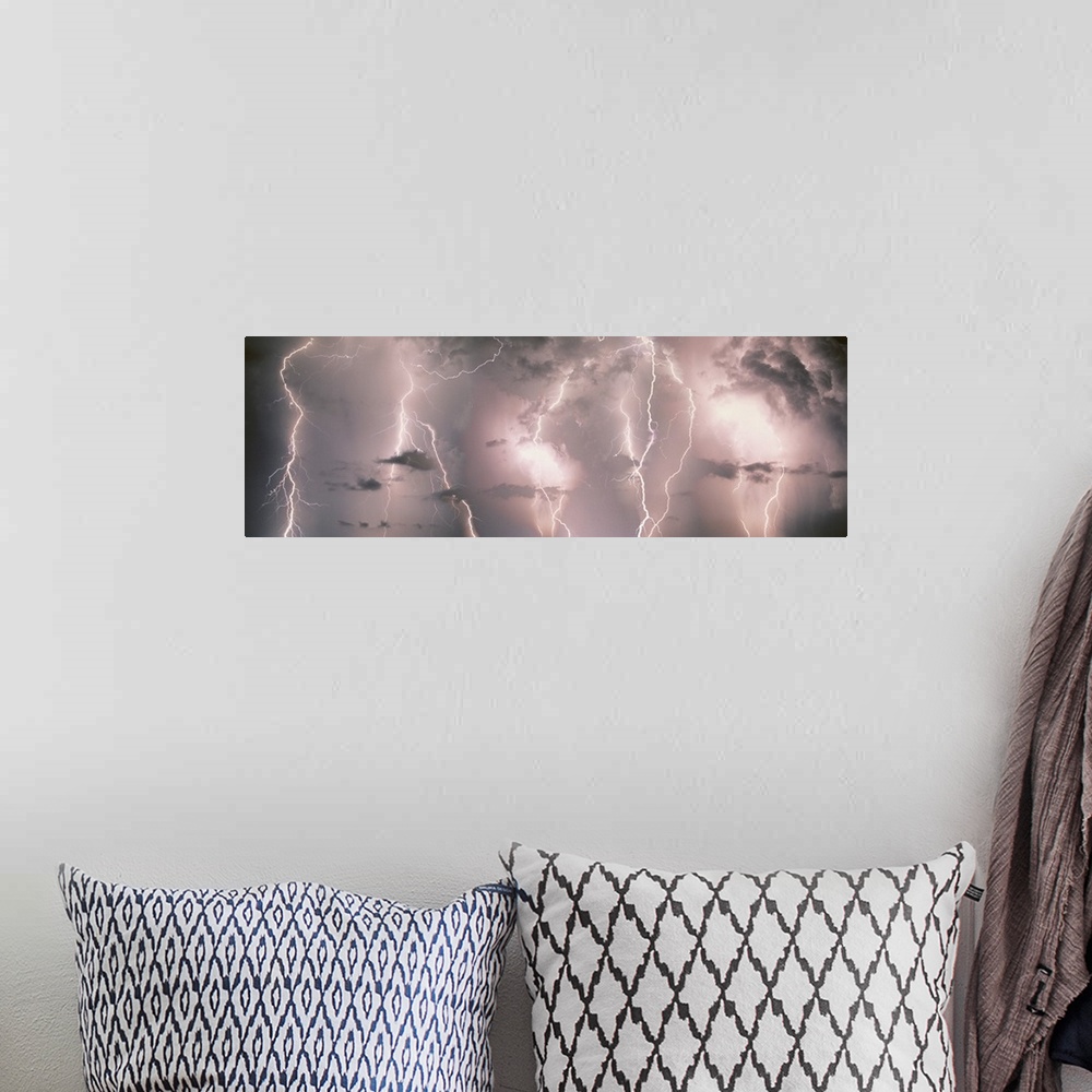 A bohemian room featuring Panoramic canvas of lightning strikes up close against a stormy lit up sky.