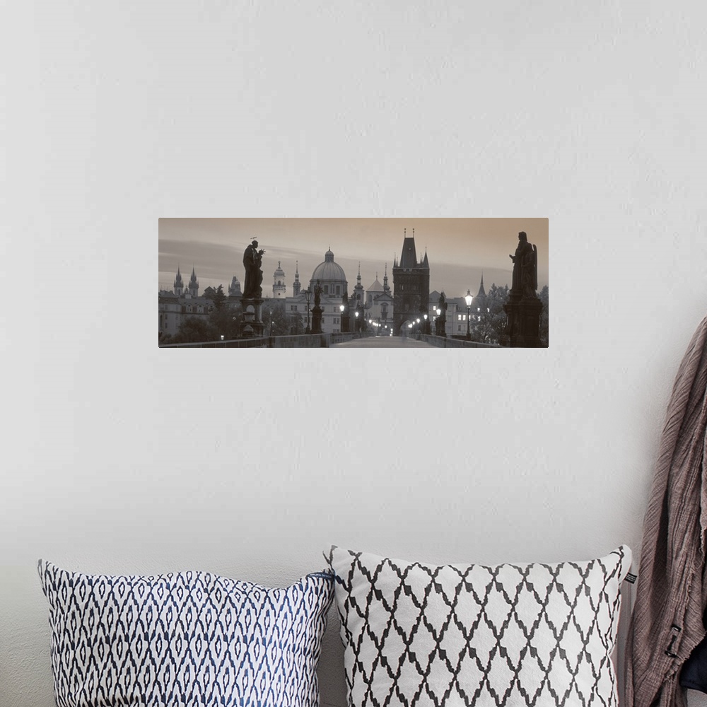 A bohemian room featuring Panoramic photograph of city with lit up street lamps on overpass walkway.