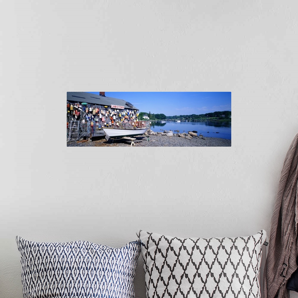 A bohemian room featuring Panoramic photograph taken of a lobster shack with small buoys lining one side of it that sits on...