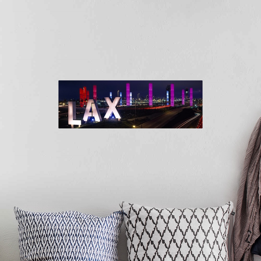 A bohemian room featuring Large panoramic photograph of the Los Angeles International Airport with large LAX letters by a h...