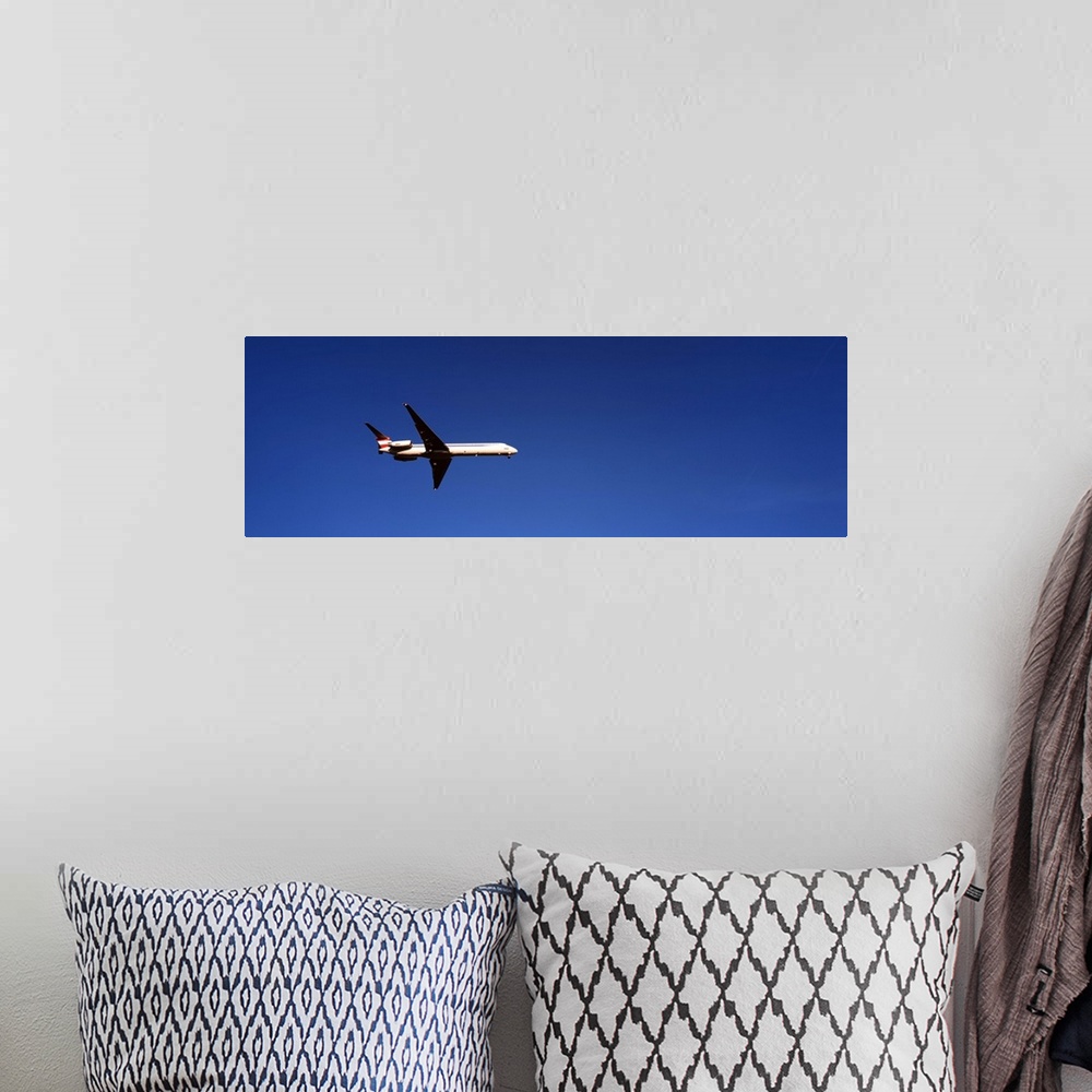 A bohemian room featuring Low angle view of an airplane flying, McDonnell Douglas MD-80