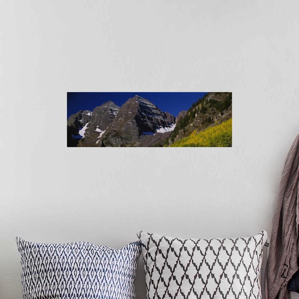A bohemian room featuring Panoramic photo print of a rugged mountain range up close.