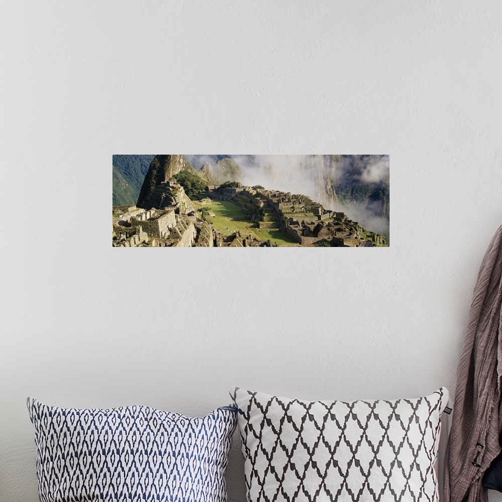 A bohemian room featuring Oversized landscape photograph of Machu Picchu in the sunlight, thin clouds in the background, in...