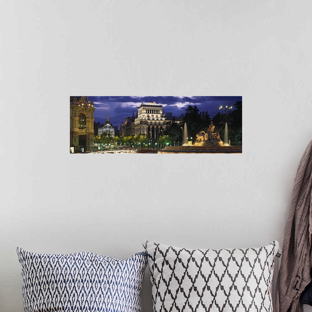 A bohemian room featuring Panoramic photo of old Spanish buildings around a traffic circle with long exposed car lights goi...