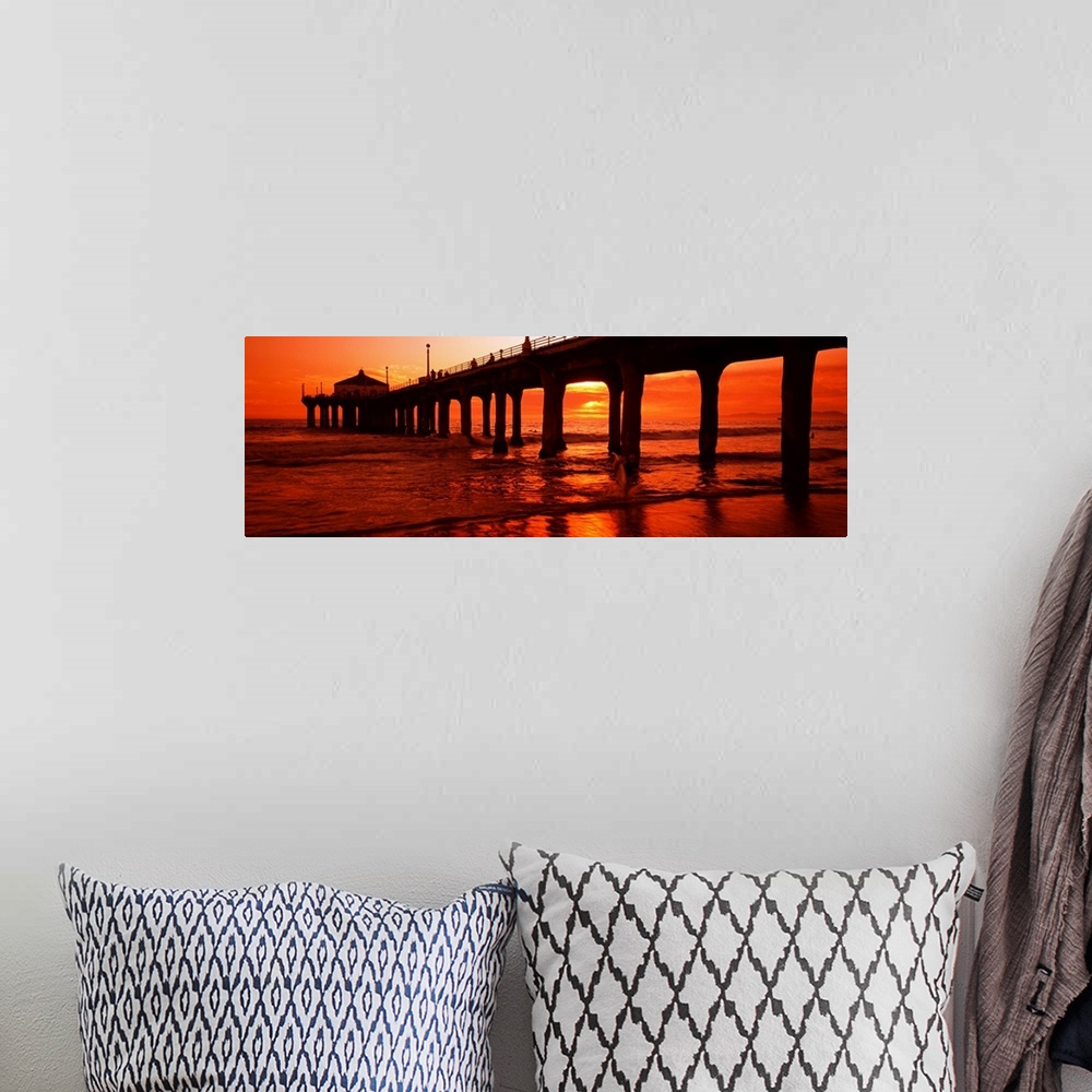 A bohemian room featuring Panoramic photograph on a big canvas of a silhouetted Manhattan Beach Pier at an angle, in front ...