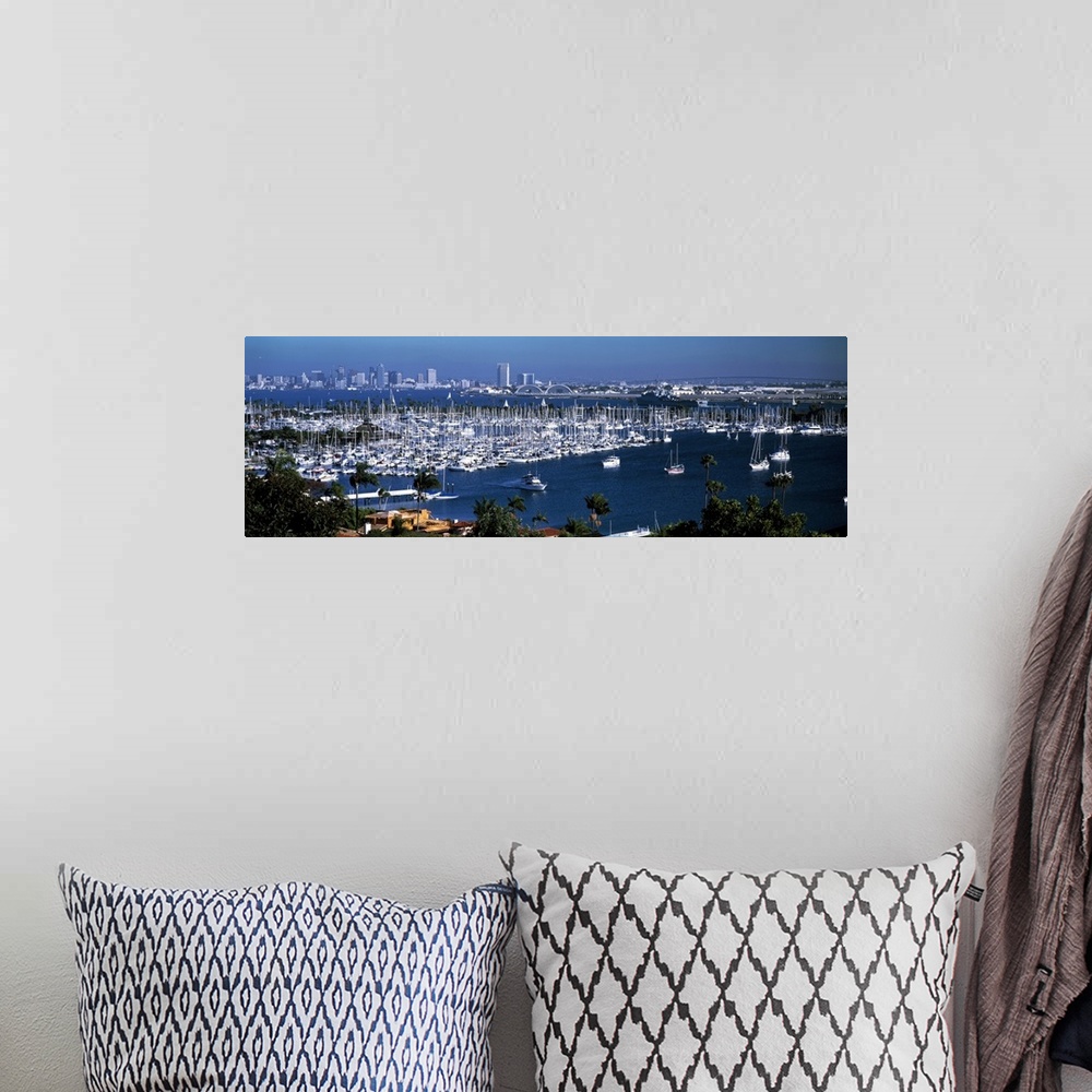 A bohemian room featuring Panoramic photograph on a large wall hanging of a marina packed with boats, in front of the San D...