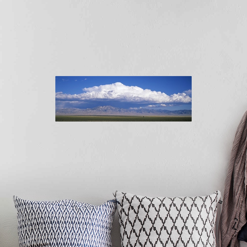 A bohemian room featuring Mountains w\ cumulus clouds NV
