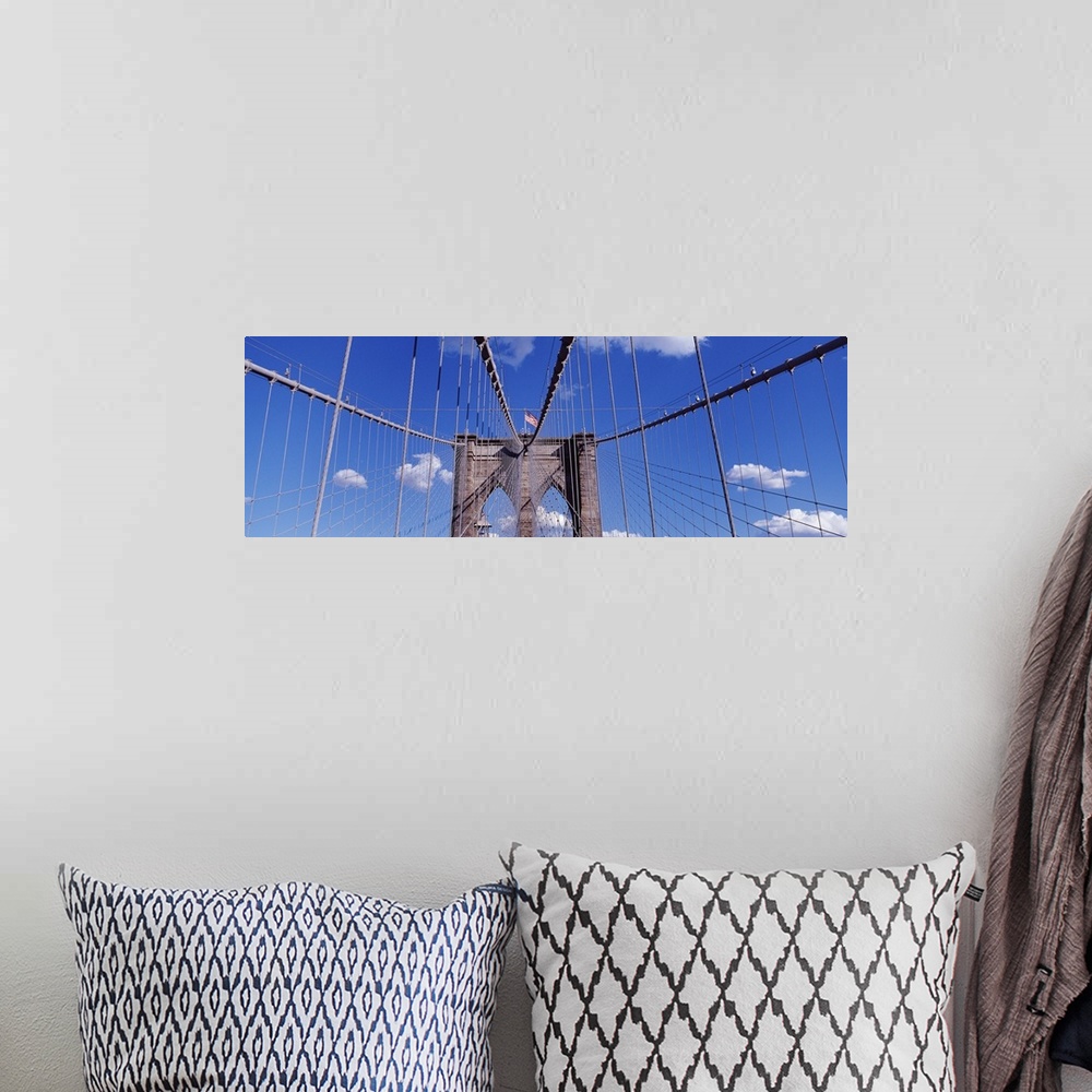 A bohemian room featuring Panorama of bright blue skies behind the Brooklyn Bridge in New York City.