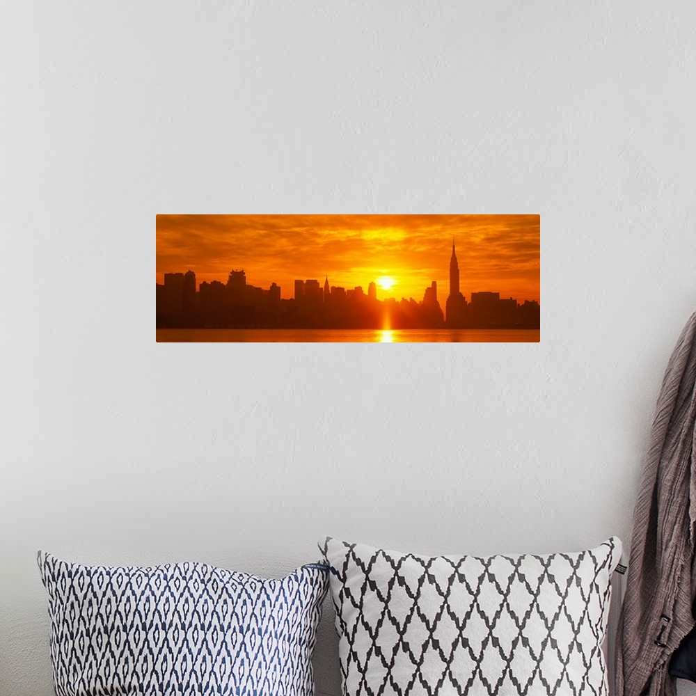 A bohemian room featuring This panoramic photograph shows the sun rising over Manhattan and making silhouettes of the city ...