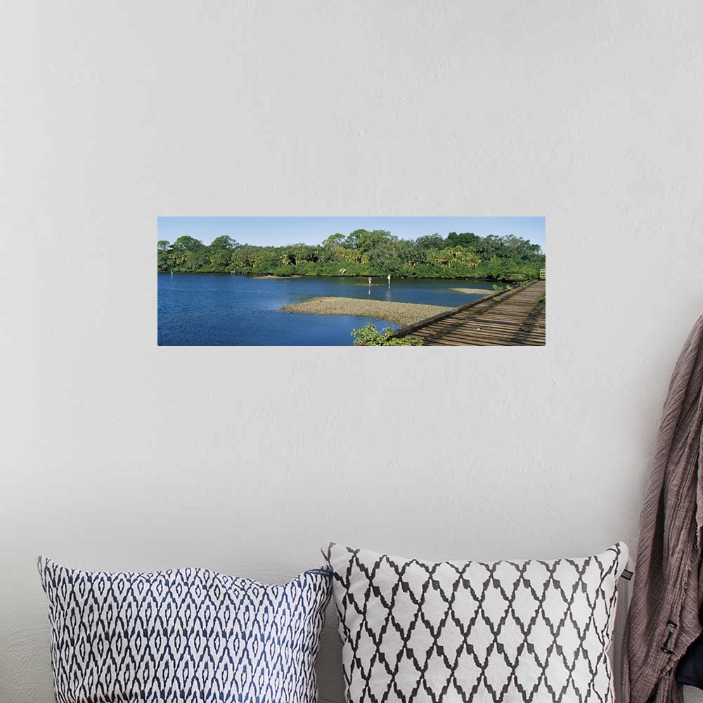 A bohemian room featuring Old railroad trestle across a shallow bay at low tide showing oyster beds, Nokomis, Sarasota Coun...
