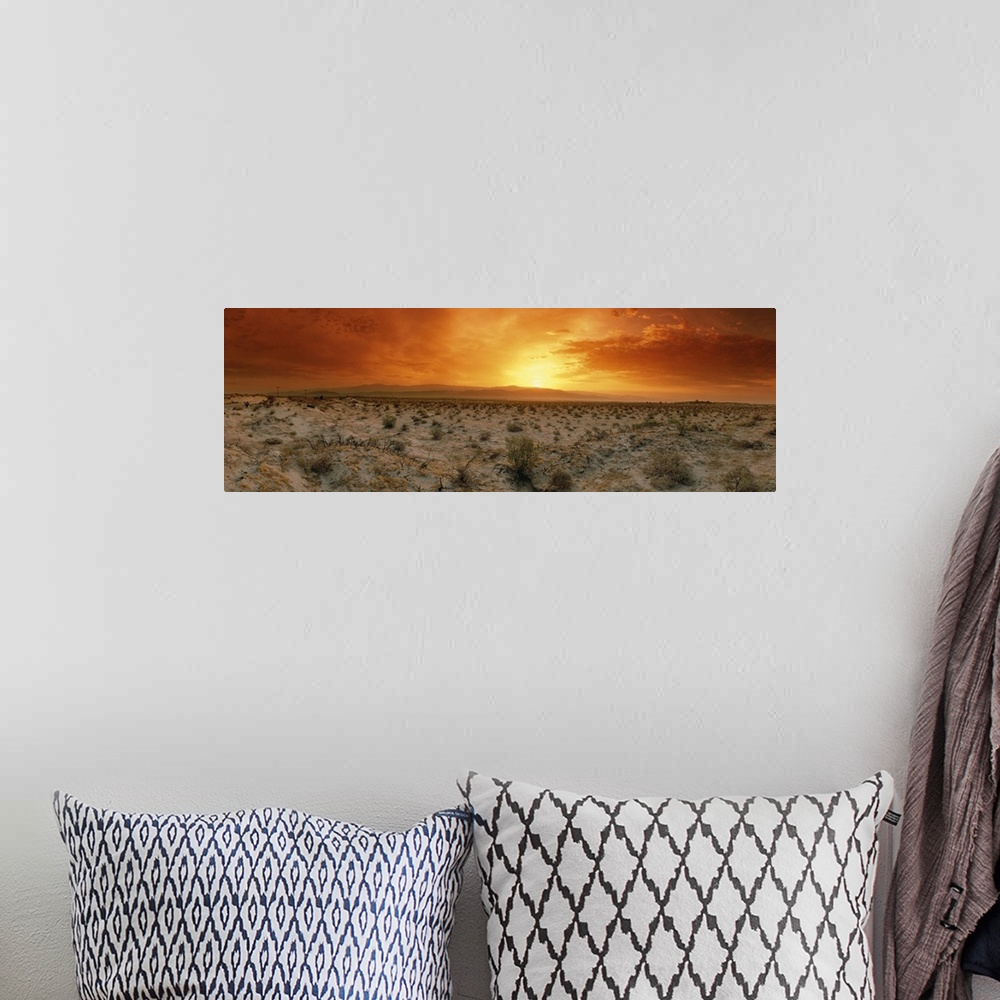 A bohemian room featuring Big, horizontal photograph of a fiery sunset over the desert in Palm Springs, California.