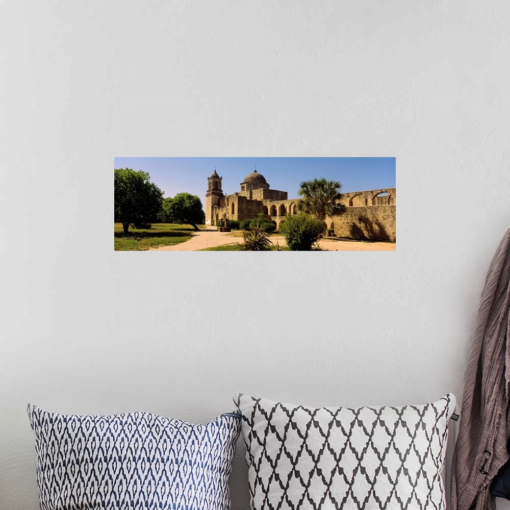 A bohemian room featuring Panoramic photograph of a brick path leading toward the historic Mission San Jose, surrounding by...