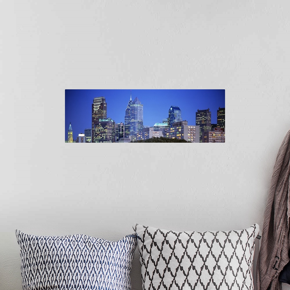 A bohemian room featuring Panoramic photograph of the Philadelphia skyline during night with the buildings windows illumina...