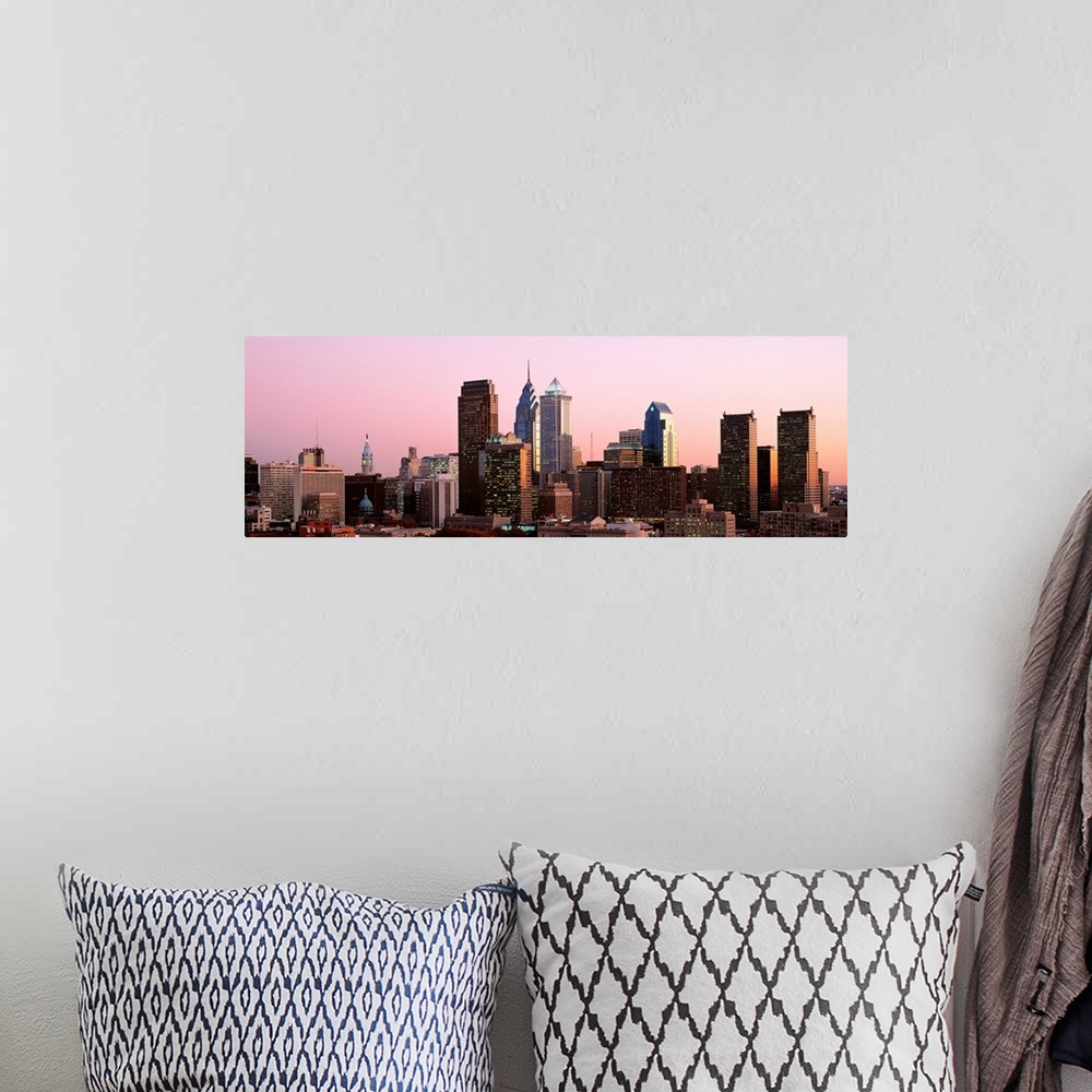 A bohemian room featuring The skyline of Philadelphia, Pennsylvania against a hazy sunset sky.