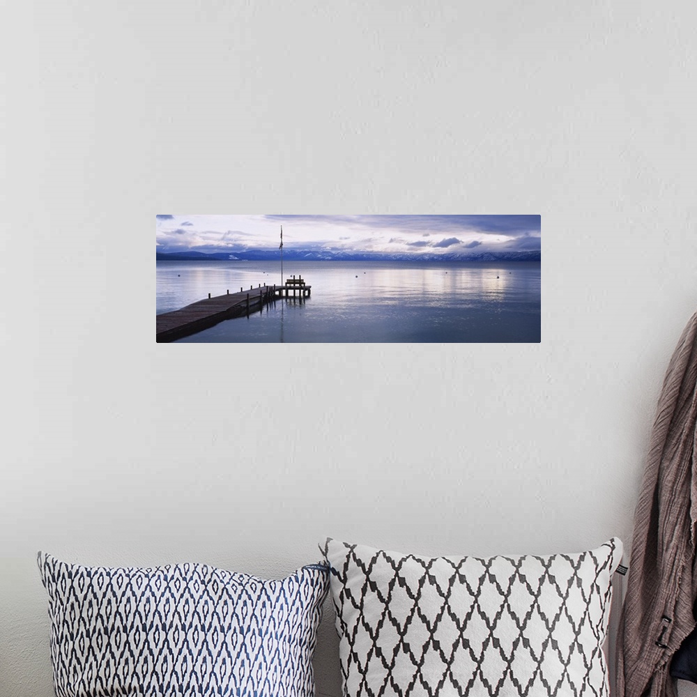 A bohemian room featuring Large dock on Lake Tahoe in California with mountains in the background.