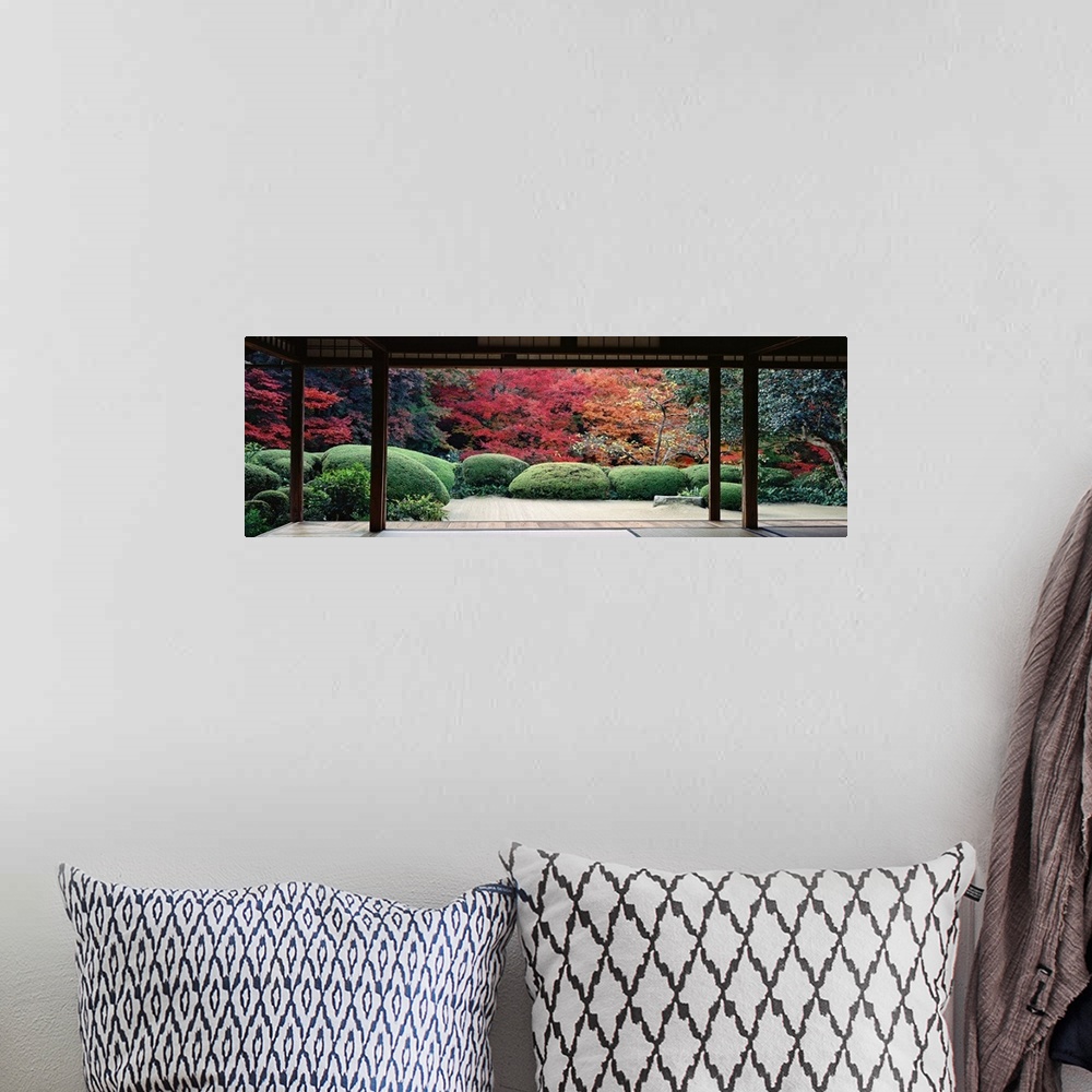 A bohemian room featuring This panoramic photograph is taken from inside a temple and looking out into a forest filled with...