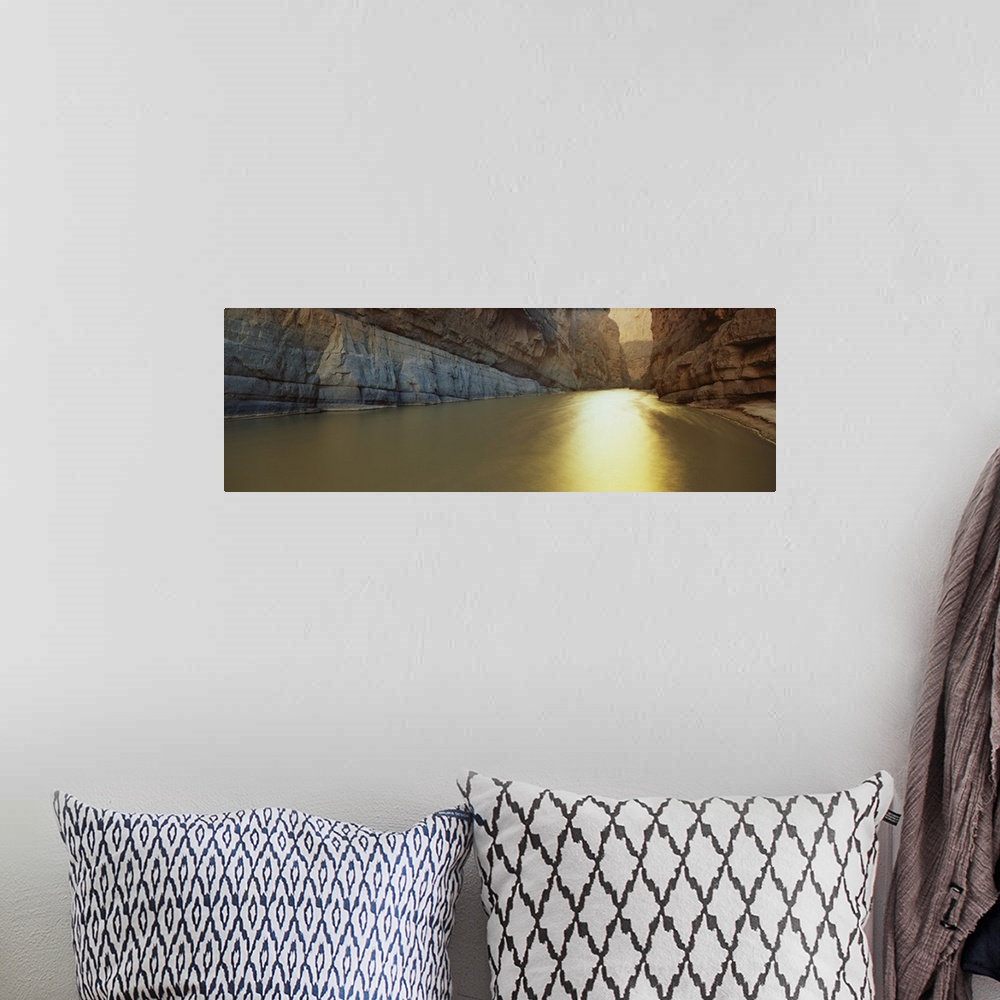 A bohemian room featuring Panoramic picture looking down the Rio Grande River that cuts between immense cliffs.