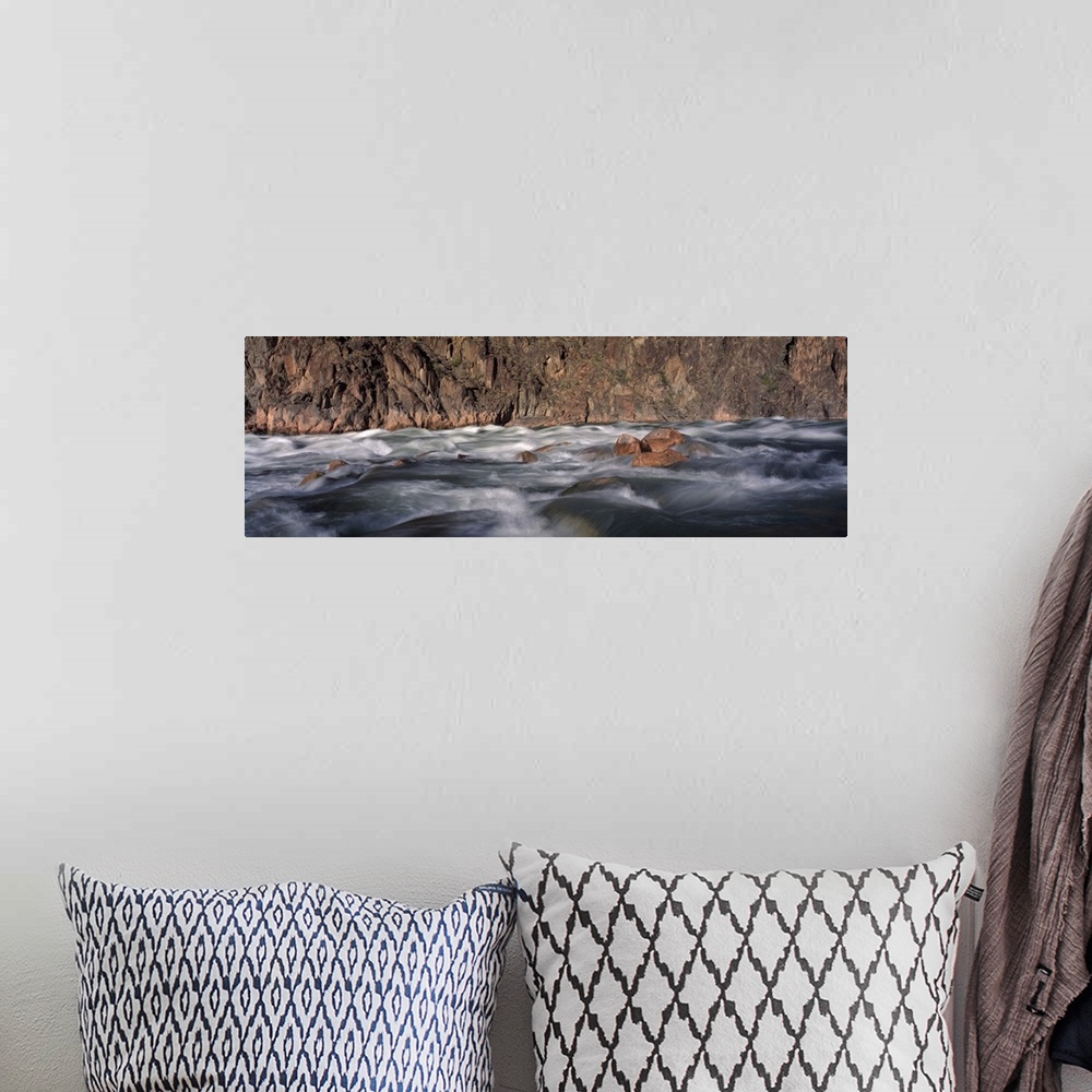 A bohemian room featuring Panoramic image of the rushing Colorado River rapids at the Grand Canyon in Arizona.