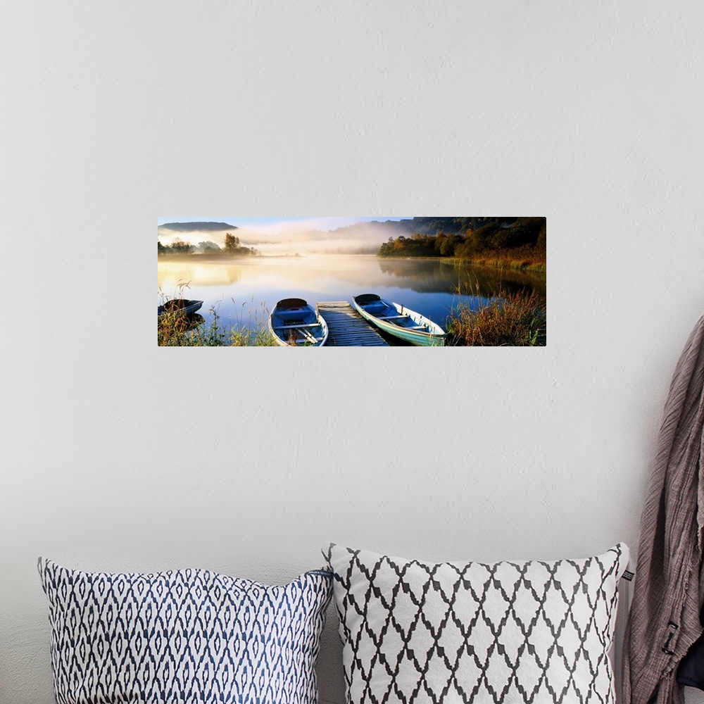 A bohemian room featuring Panoramic photograph showcases rowboats sitting next to a dock on a lake in Grasmere within Cumbr...