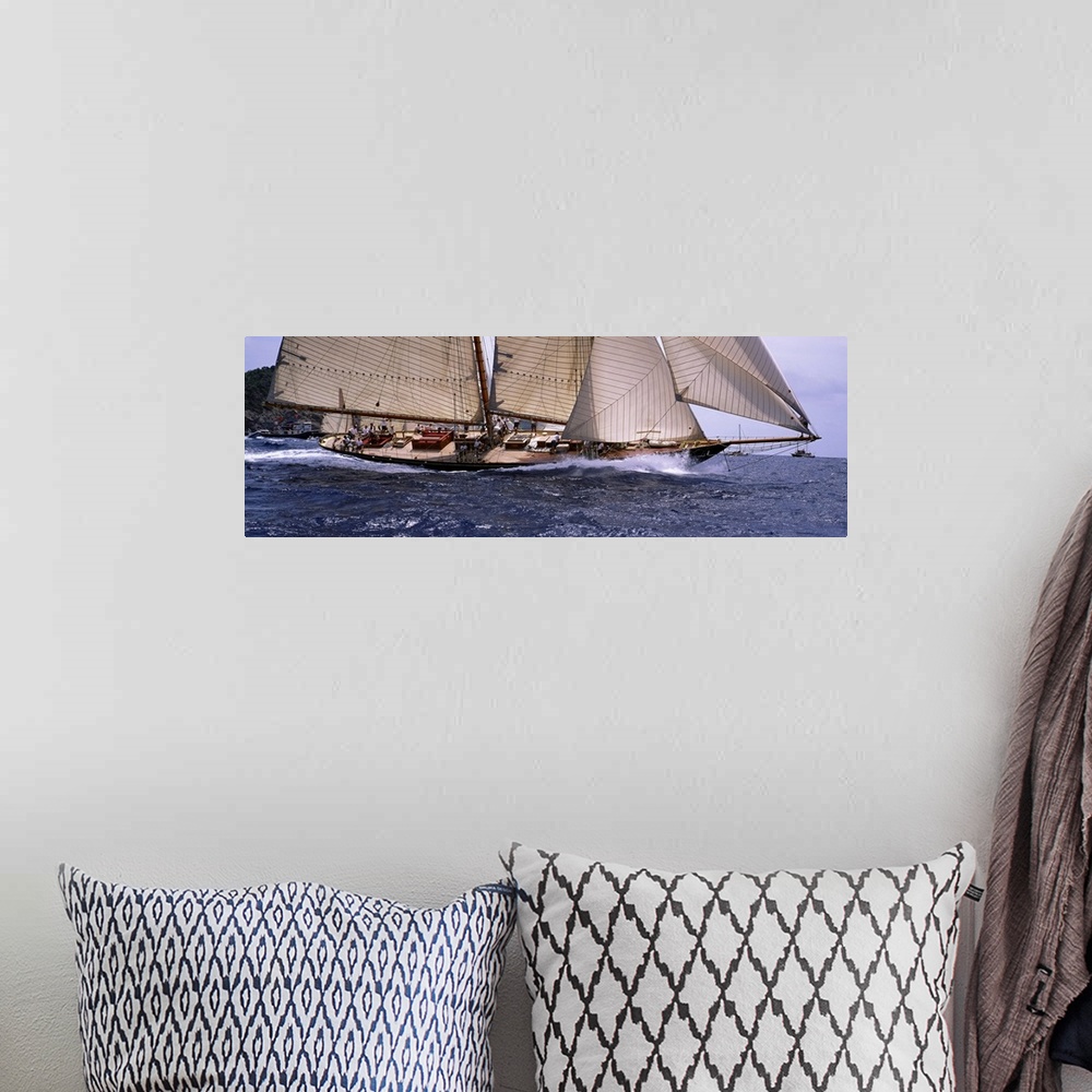 A bohemian room featuring The body of a large sail boat is photographed in wide angle view as one side leans down into the ...
