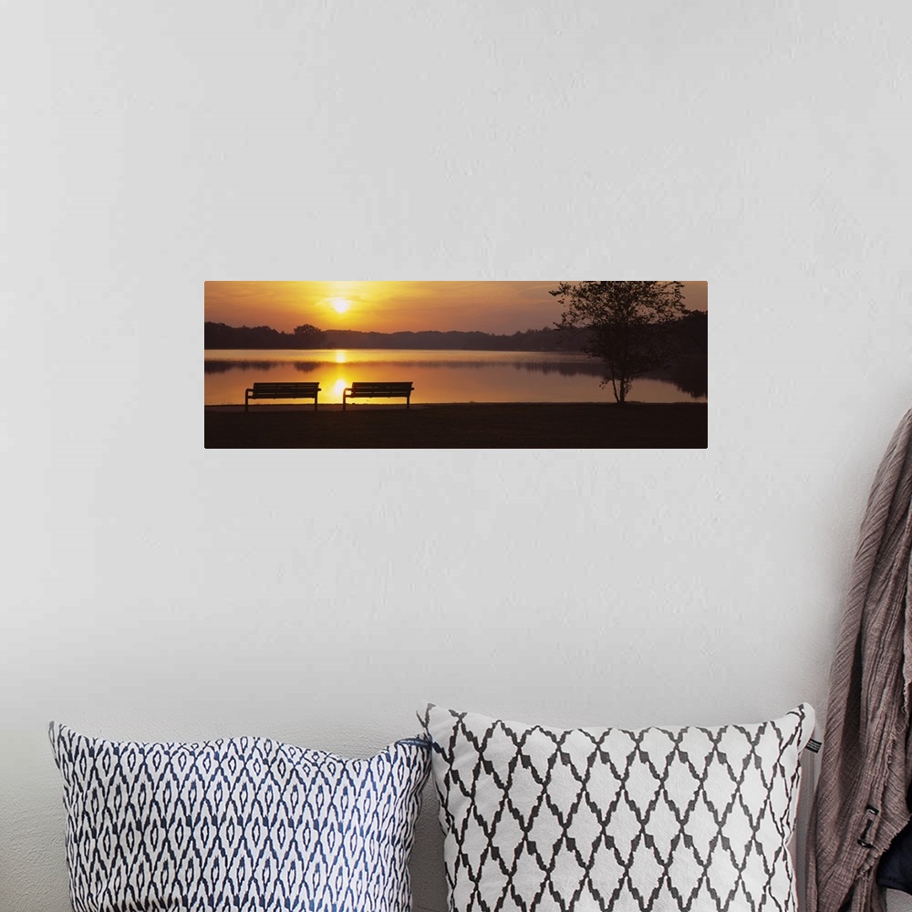 A bohemian room featuring Panoramic photograph of park benches near water's edge at sunset with forest silhouette in the di...