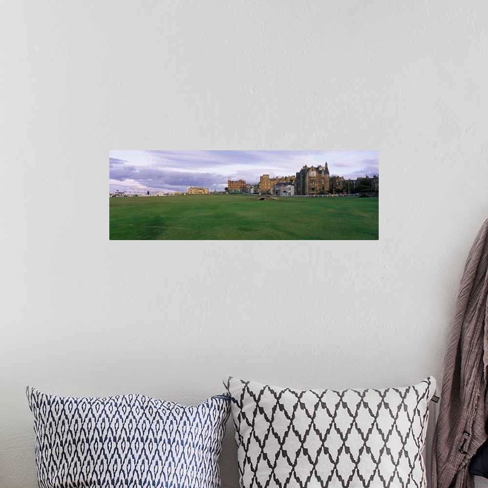 A bohemian room featuring Panoramic picture taken of buildings that are a part of a famous golf club in Scotland.