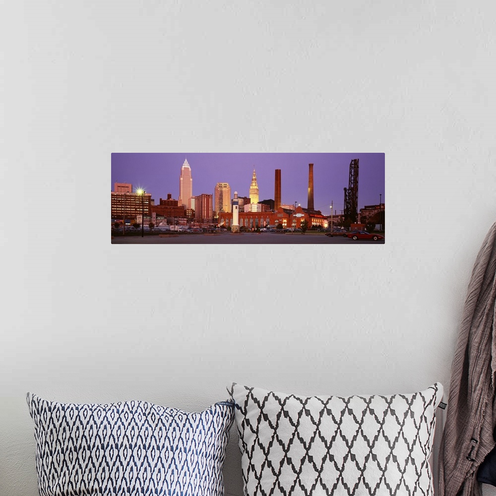 A bohemian room featuring Panoramic photograph of skyscrapers in Cleveland, Ohio, lit up at night.