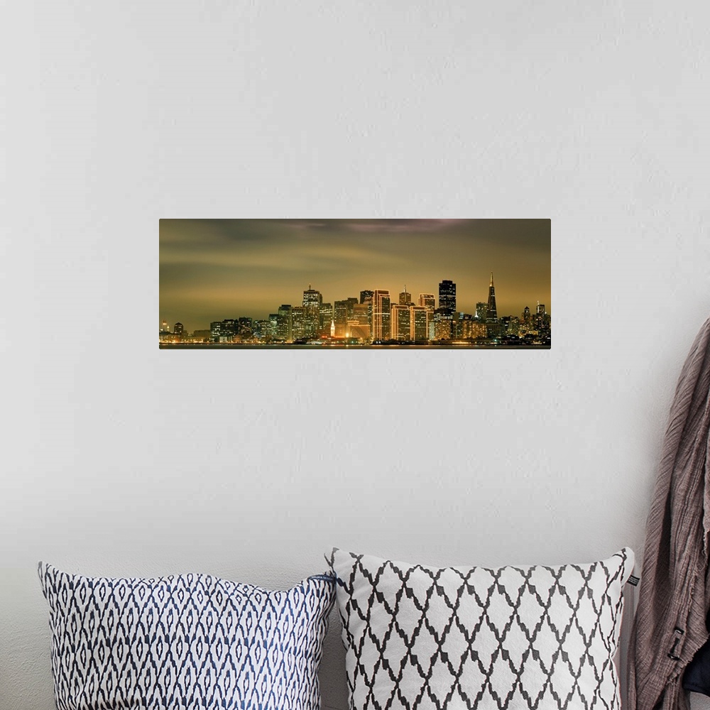 A bohemian room featuring Large panoramic image of the San Francisco skyline lit up at dusk.