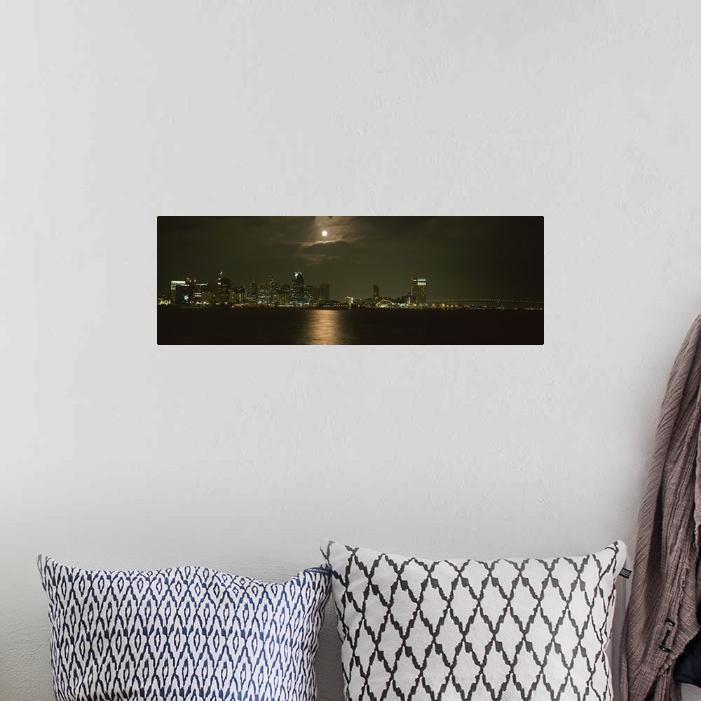A bohemian room featuring Panoramic photograph taken at nighttime shows a distant view of the brightly lit skyline within a...