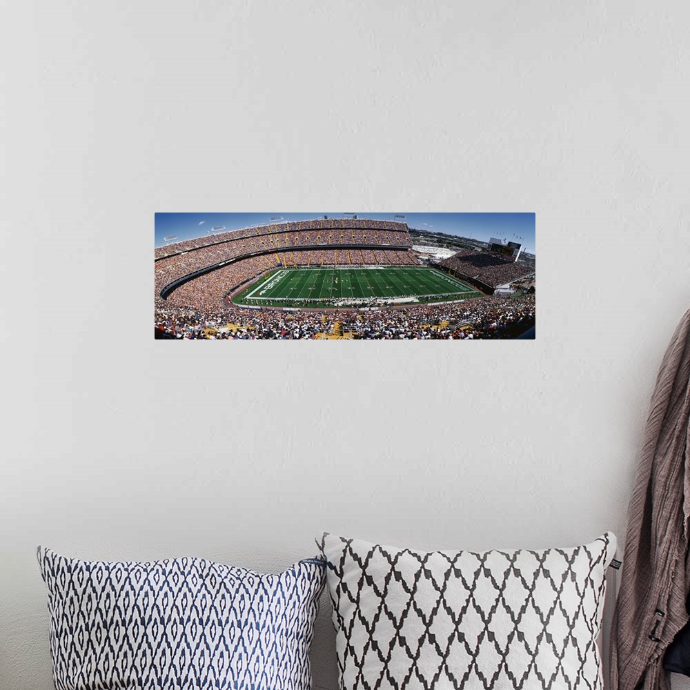 A bohemian room featuring A wide angle shot of a full Broncos stadium on a bright, sunny day.