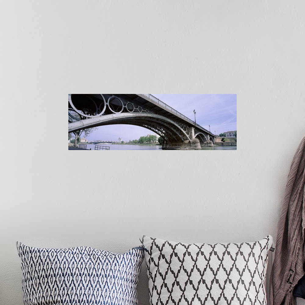A bohemian room featuring Spain, Seville, Low angle view of Isabel II Bridge over Guadalquivir River