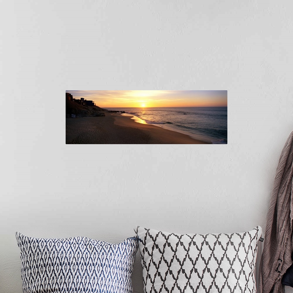 A bohemian room featuring Panoramic photo of the sun rising over the beach in Los Cabos, Mexico.