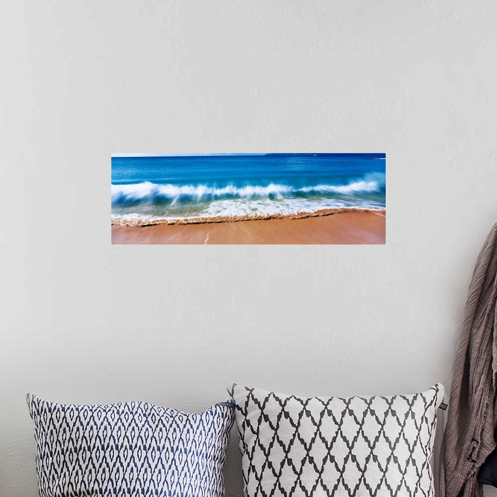 A bohemian room featuring Giant, landscape photograph of a large wave crashing into the sands of Big Makena Beach in Maui, ...