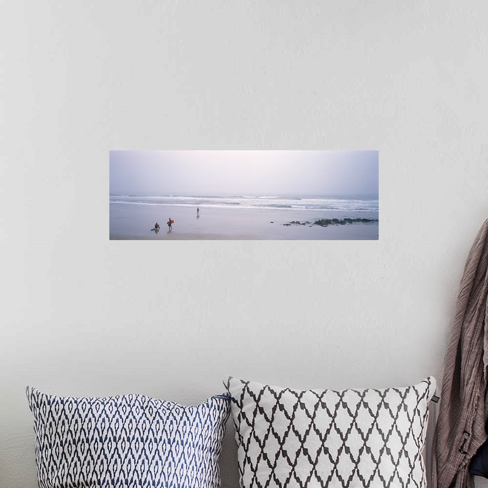 A bohemian room featuring Surfers carrying surfboards on the beach, San Mateo County, California,