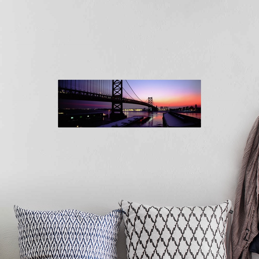 A bohemian room featuring Long horizontal photo print of a big bridge in Philadelphia reaching across a river at sunset.