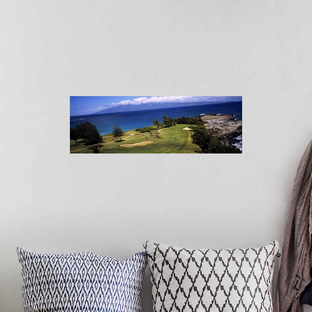 A bohemian room featuring This panoramic photograph is a golf landscape overlooking the ocean from a tropical island.