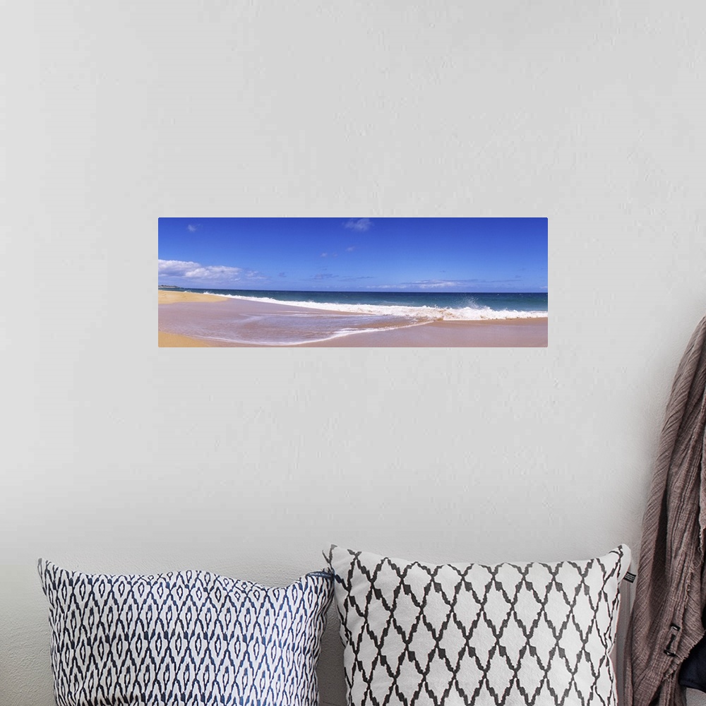 A bohemian room featuring This is a landscape panoramic photograph of a flat sandy shoreline and a calm sea with few clouds...