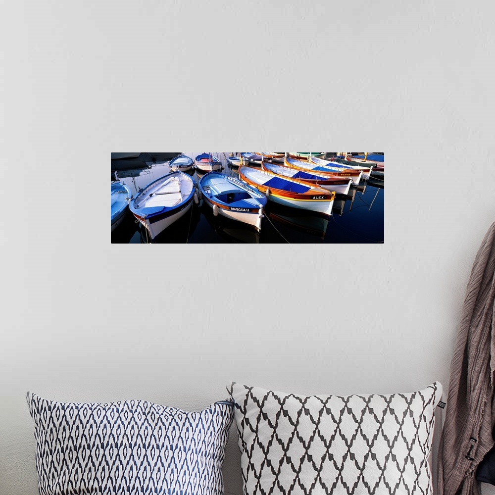 A bohemian room featuring Panoramic photograph of colorful boats strung up in rows.