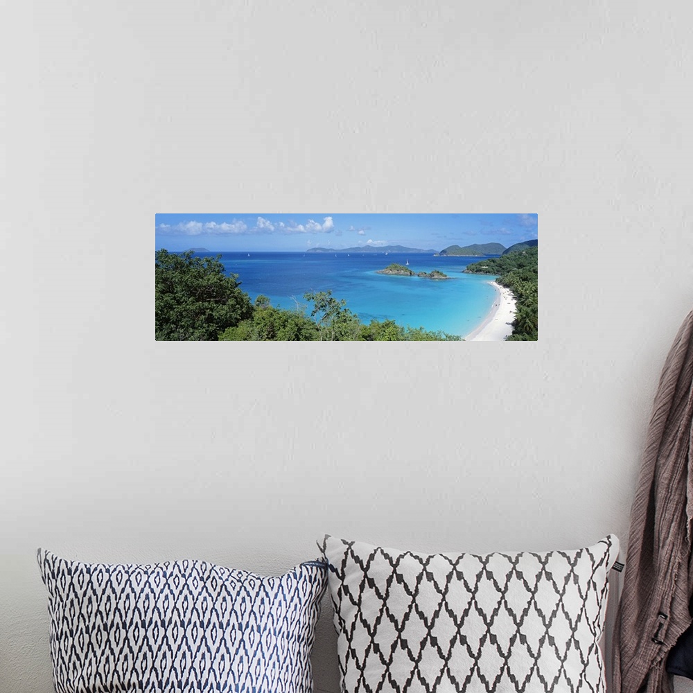 A bohemian room featuring Panoramic photo of a tropical sandy beach, with lush jungle vegetation around the edge, sailboats...