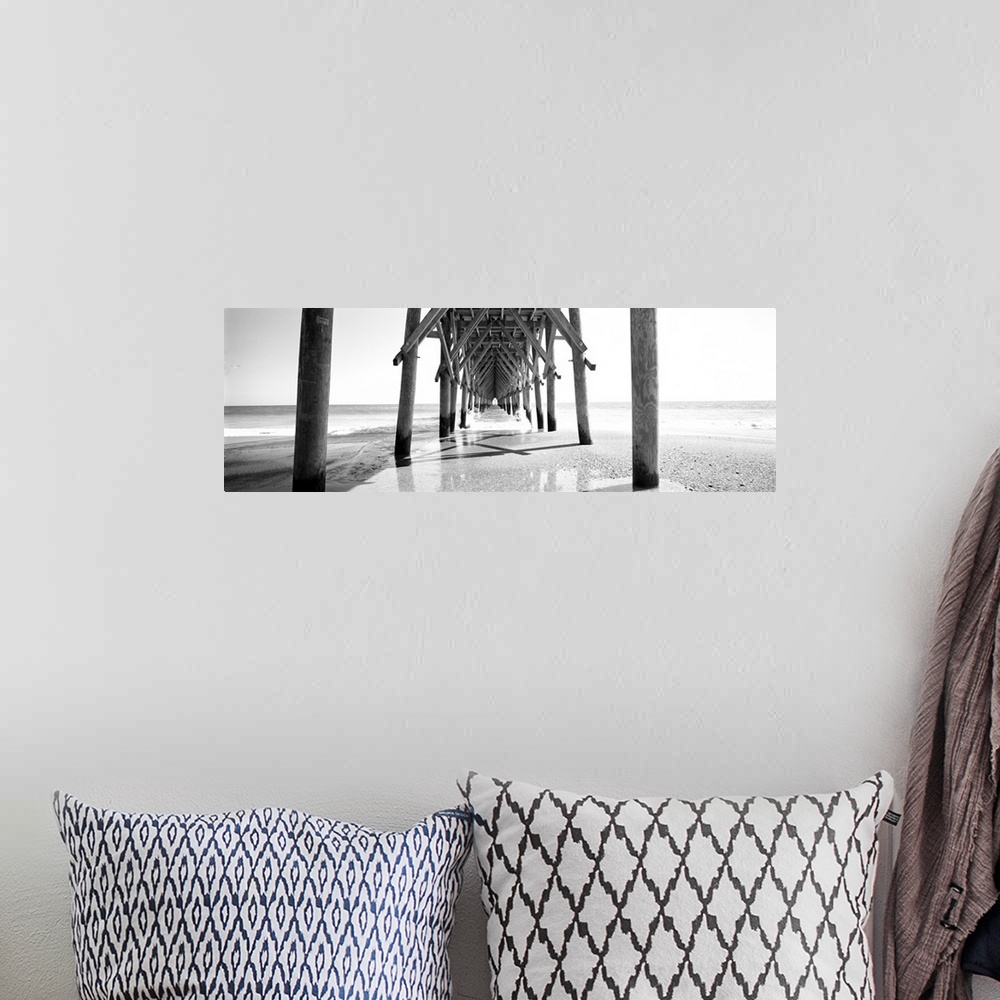 A bohemian room featuring Horizontal, huge, black and white panoramic photograph taken under a wooden pier, looking out tow...