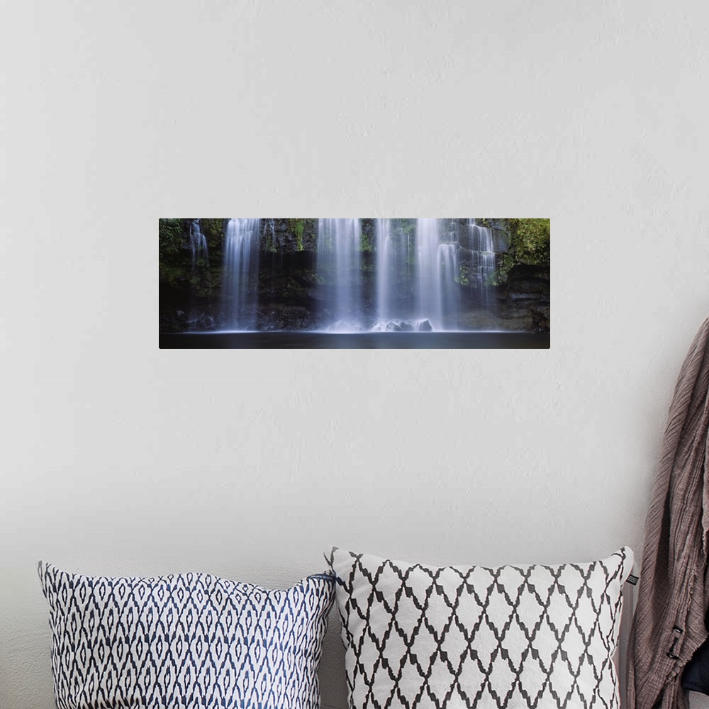 A bohemian room featuring Multiple cascades fall over a moss covered rock face into a pool in this panoramic photograph of ...