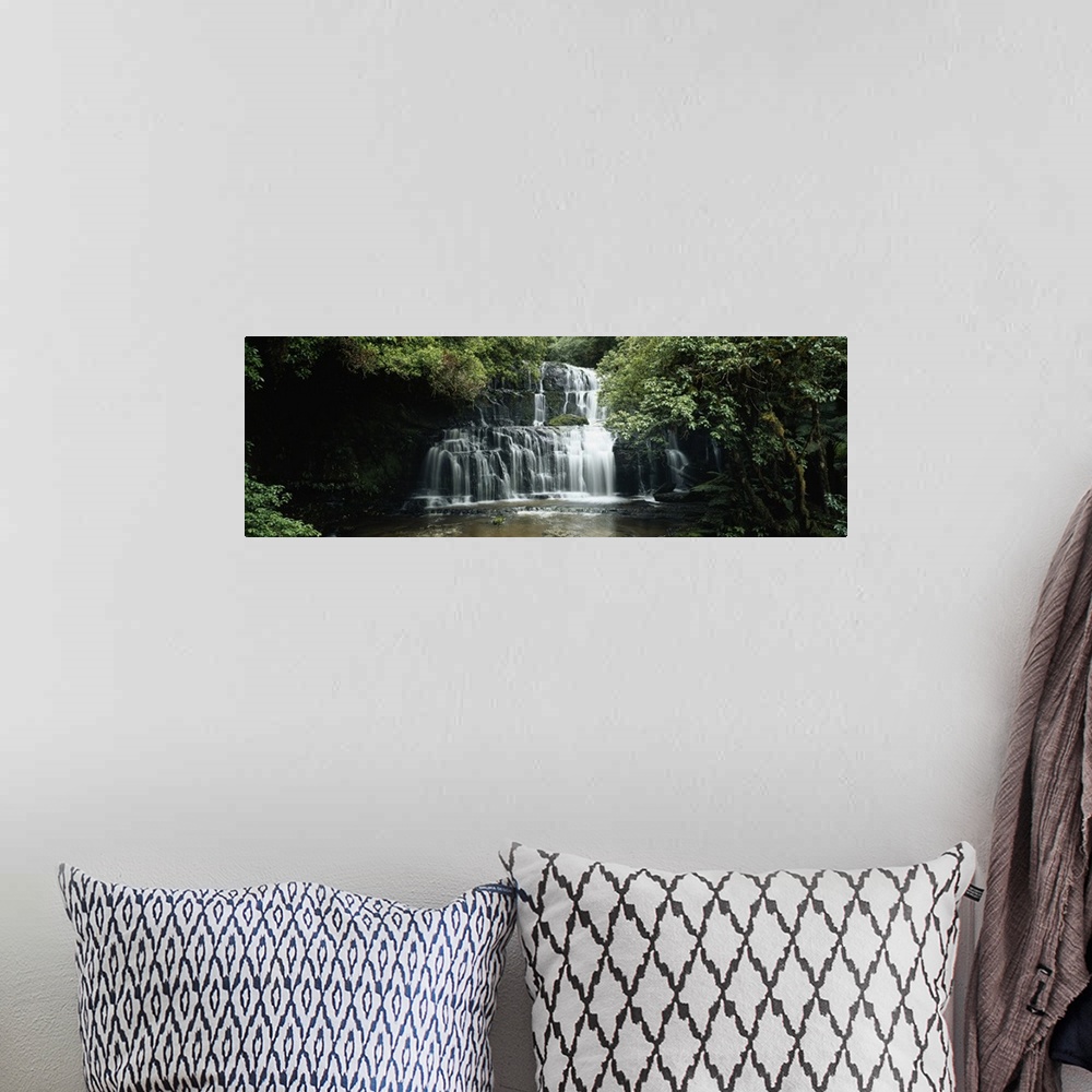 A bohemian room featuring Wide angle photograph of green trees and foliage surrounding Purakaunui Falls in the Catlins, on ...