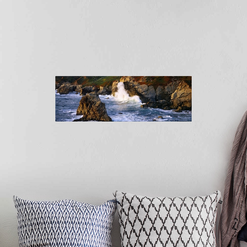 A bohemian room featuring Horizontal photo print of waves crashing into rocky cliffs in the Pacific Ocean and rock formatio...