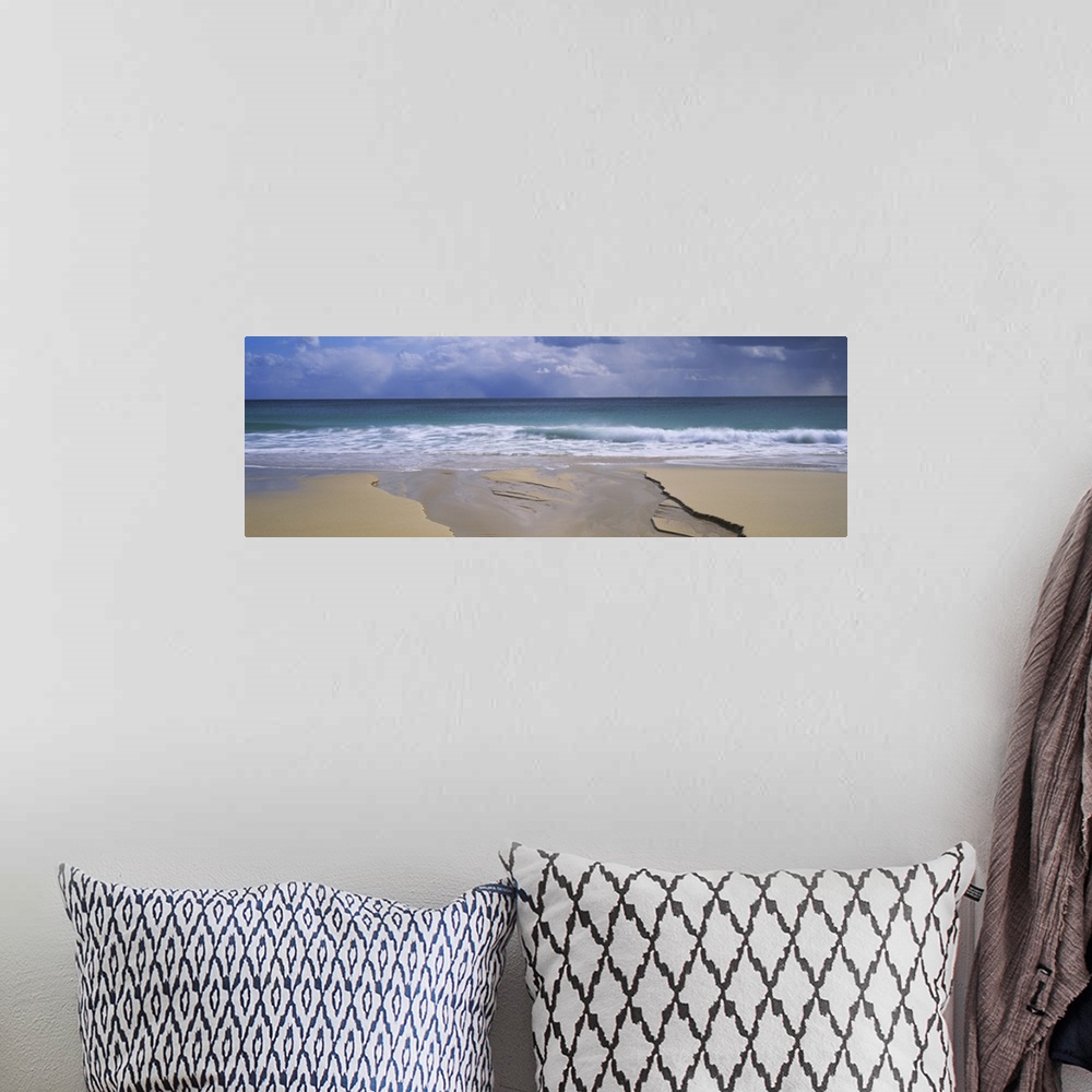A bohemian room featuring Waves breaking on the beach, Porthcurno Bay, Cornwall, England
