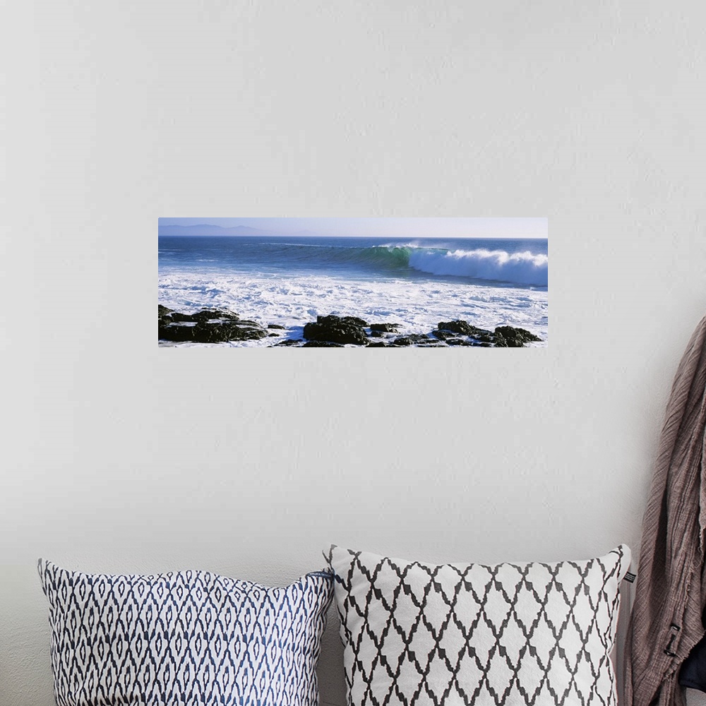 A bohemian room featuring Long image on canvas of big waves crashing onto a rocky shore.