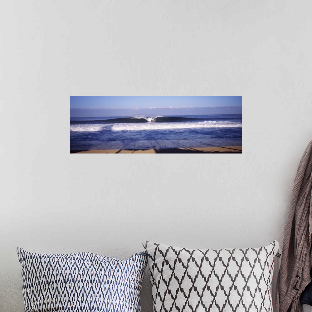 A bohemian room featuring Panoramic photo print of a big wave breaking in the middle washing ashore in Hawaii.