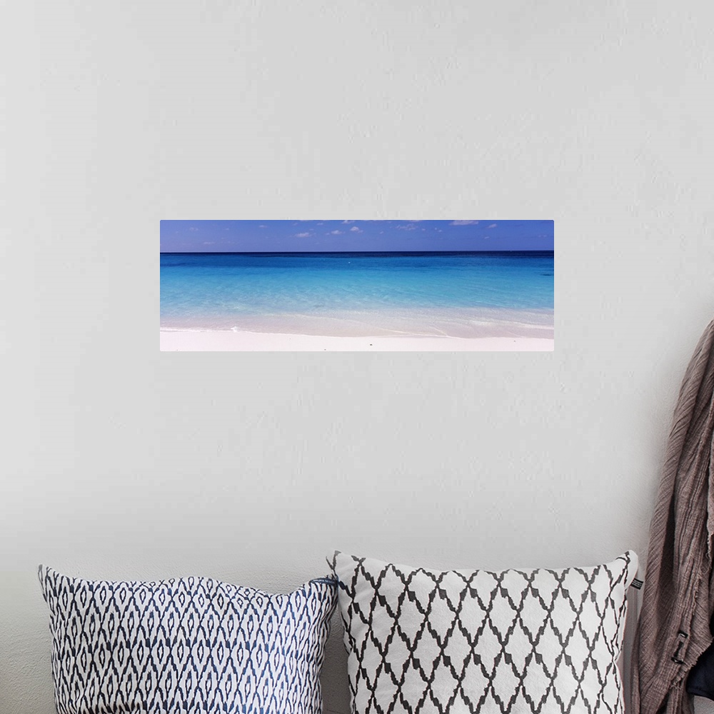 A bohemian room featuring In this large panoramic photograph crystal clear water trickles onto a white sand beach in Shoal ...