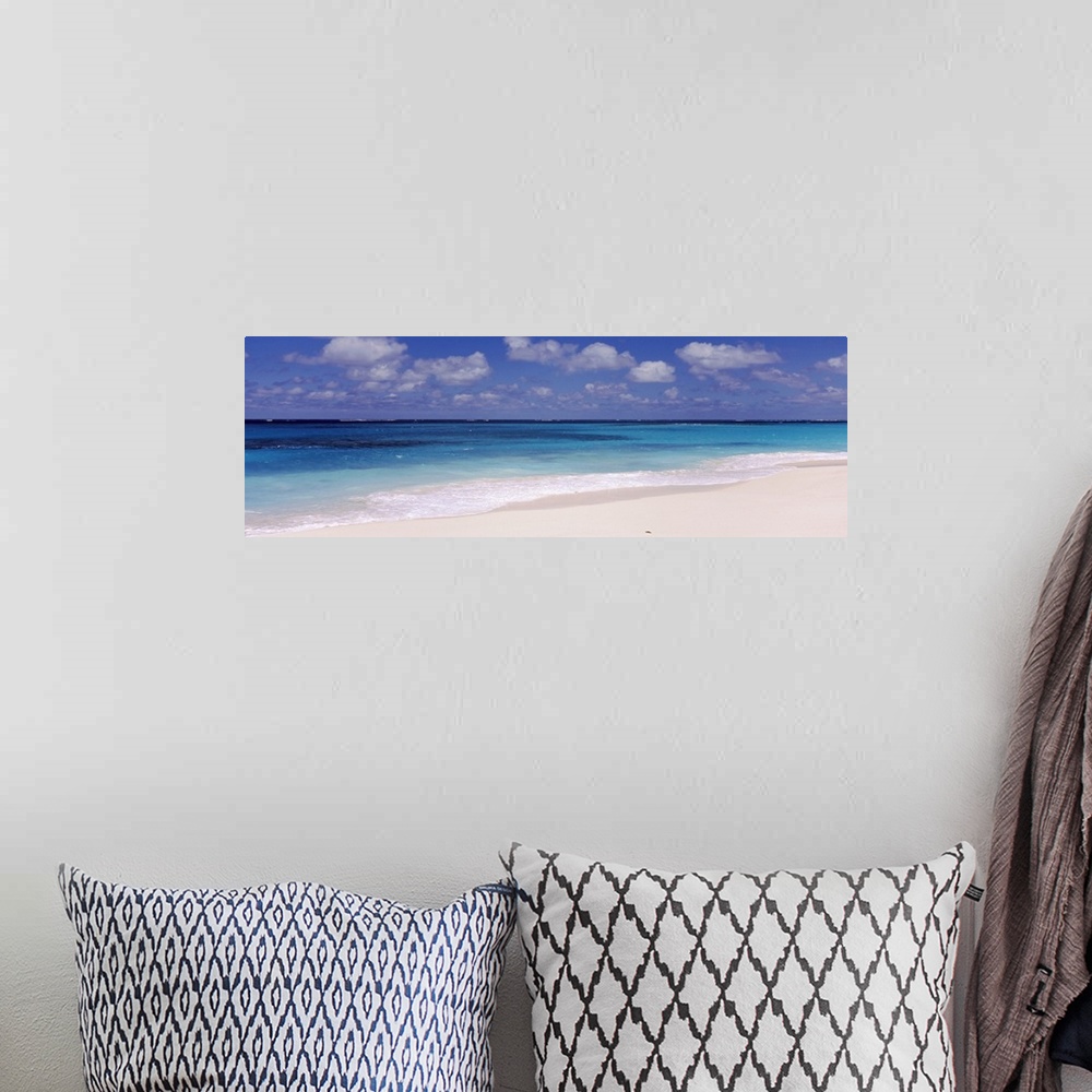A bohemian room featuring Panoramic photograph of the ocean against the sand on a cloudy day at Shoal Bay Beach in Anguilla.