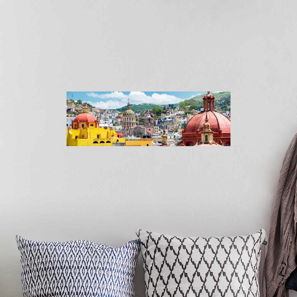 A bohemian room featuring Panoramic photograph of a cityscape in Guanajuato, Mexico, with colorful buildings and church dom...
