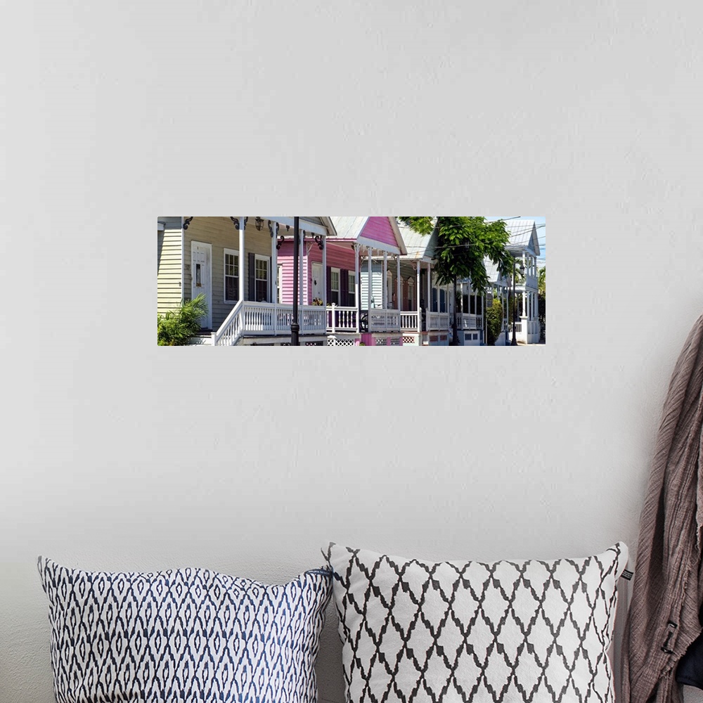 A bohemian room featuring A row of classic houses in Key West, with one house painted bright pink.